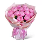 Bouquet of 20 vibrant pink peonies wrapped in delicate pink paper, tied with satin ribbons.