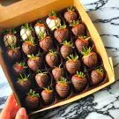 Box of 25 chocolate-covered strawberries, some dark, some white chocolate, decorated with drizzles and sprinkles.