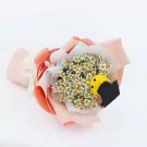 Graduation bouquet with daisies, ping pong mum, and a graduation cap charm.