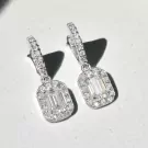 Diamond and moissanite emerald-cut drop earrings, showcasing their sparkle and intricate settings.