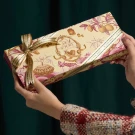 Le Souri Chocolate Gift Box with floral and lemon designs, tied with a ribbon.