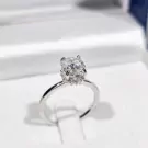 Oval-cut moissanite diamond ring with white gold plated band.
