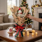 Christmas bouquet with a snowman centerpiece, red bow, and festive wrapping paper.