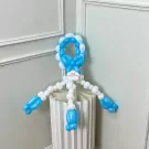A balloon sculpture of a person in blue and white balloons.