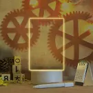 Neon-edged customizable lamp with drawing board, marker, and calendar on a desk.