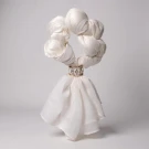 White scarf tied into a circle with a floral ring, resembling a garland.