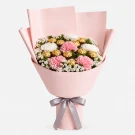 Pink and white carnations with Ferrero Rocher chocolates in a pink bouquet.