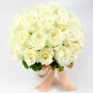 Round white box filled with 25 white roses tied with a peach ribbon.