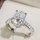 Oval-cut moissanite diamond ring with a white gold plated sterling silver band.