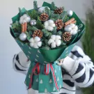 Christmas bouquet with pine, cotton, cinnamon, pine cones and silver ornaments.
