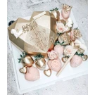 Gold heart chocolate gift box with smashable center, decorated strawberries, and cupid figures.