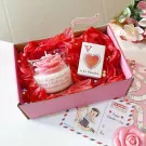 Valentine's gift box with rose candle, "V is for Valentine" card, and love-themed decorations.