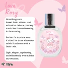 A bottle of "Love Rosy" floral fragrance perfume with a cute cat illustration on the label.