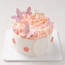 Pink rose bouquet and mini cake with butterfly decorations.