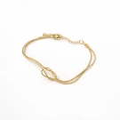 Gold-tone bracelet with double strands and an infinity knot centerpiece on a white background.