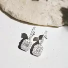 Diamond emerald-cut moissanite drop earrings with pavé diamond halos.