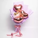 Pink heart balloons and Ferrero Rocher chocolates in a lavender bouquet with pink ribbon.