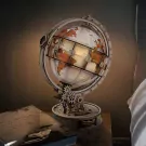A luminous, rotating DIY globe model on a wooden stand with intricate gears.