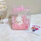 Cute seal-shaped candle in a clear box with pink tissue paper and a pink bow.