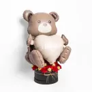 A teddy bear balloon holds a heart that says "I love you," surrounded by red carnations and chocolates.