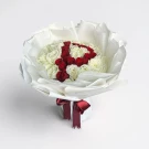 Bouquet of white and red roses arranged to form the initial "P," wrapped in white paper and tied with a red ribbon.