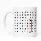 White mug with a word puzzle design. The letter 'M' in the word puzzle is circled in red.