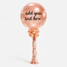 Rose gold glitter balloon with decorated with small balloons and fringe.