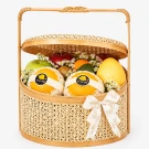 Bamboo fruit basket with pears, apples, kiwi, mandarin, avocado and small white flowers.