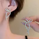 Sparkling silver ribbon earrings with cubic zirconia.