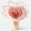 A pink money bouquet of folded 5,000 Baht bills in a vase with a gold ribbon.
