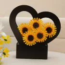 LEGO sunflowers in a black heart-shaped basket, with real sunflowers in the foreground.