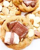Close-up of chocolate chip cookies topped with Kinder Bueno and melted chocolate.