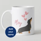 White mug with dachshund illustration, pink hearts, and text "Ploy".