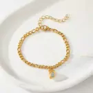 Gold figaro chain bracelet with a gold half-heart pendant containing a blue stone.