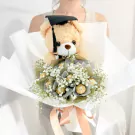 Graduation bouquet with teddy bear, Ferrero Rocher chocolates, and white gypsophila.