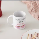 White mug with "you'll always be my best-tea" and two smiling teacups.