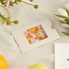 Sliding photo card with "Happy Valentines" and floral graphics, next to flowers.