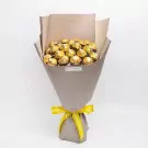 Bouquet of 22 Ferrero Rocher chocolates wrapped in brown paper and tied with a yellow ribbon.
