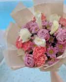 Bouquet of pink and white roses, cala lilies, pink mums, and coral carnations.