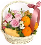 Fruit basket with pink roses, oranges, mango, dragon fruit, and longan, tied with a pink ribbon.
