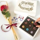 Chocolate Love Box with 9 assorted chocolates, a red rose, and a gift bag.