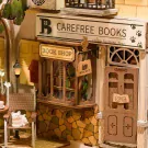 Miniature wooden bookshop scene with "Carefree Books" sign and "Book Shop" window display.