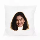White pillow with a cutout of a smiling young woman's face printed on it.