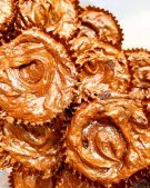 Close-up of chocolate fudge brownie bites in brown paper wrappers, showing their chewy texture.