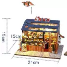 Miniature DIY sushi restaurant model kit, featuring a detailed shop interior with sushi display and wooden facade.