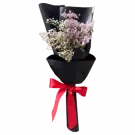Bouquet of white and pink dried limonium flowers in black wrapper, tied with a red ribbon.