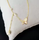 Gold necklace with butterfly pendant, pearls, and diamond accents.
