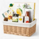 Doi Kham hamper basket with assorted food and drink products, including mango, lime, and tea.