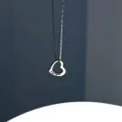 Silver heart pendant necklace with engraved text.
