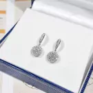 1-carat round-cut moissanite diamond halo drop earrings on a white surface.